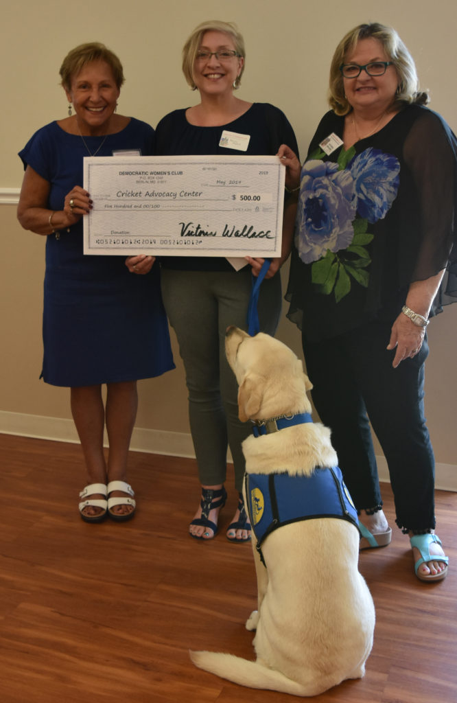 Shown in the photo, L-R: Harriet Batis, Co-Vice-President DWC; Wendy Myers, Executive Director of The Cricket Center; Vicky Wallace, President DWC; and Josiah, Cricket Center facility dog.  At their May meeting, the DWC made a $500 donation to The Cricket Center, the only child advocacy center on the lower shore.